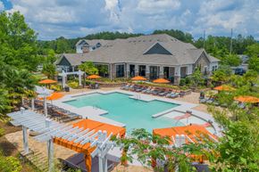 Birmingham apartment for rent - a swimming pool with orange umbrellas in front of a house