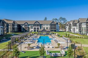 Mobile apartment for rent - A large resort with a pool and multiple buildings.
