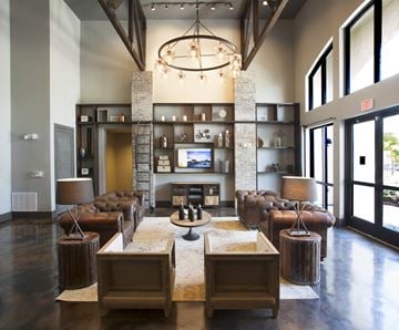 Little Rock apartment for rent - a large living room with leather furniture and a fireplace