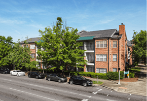 Birmingham apartment for rent - an apartment building on a city street with cars parked in front