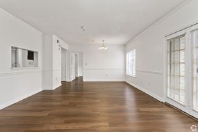 Birmingham apartment for rent - A large empty room with wooden floors and white walls.