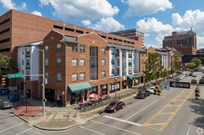 Birmingham apartment for rent - A street view of a city with a red brick building in the foreground.