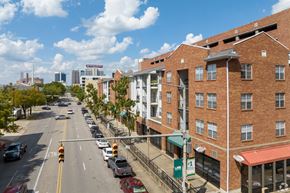 Birmingham apartment for rent - A street view of a city with cars and buildings.