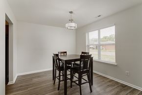 Tuscumbia apartment for rent - A dining room with a wooden table and chairs.