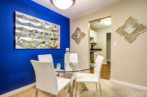 Savannah apartment for rent - A dining room with a glass table and white chairs.