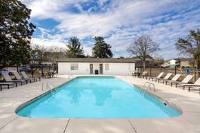 Athens townhouse for rent - A large outdoor swimming pool with chaise lounges at Magnolia Apartments in Athens, Alabama
