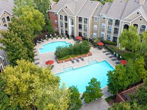 Antioch apartment for rent - an aerial view of a large swimming pool in front of an apartment building