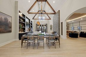 Charlotte apartment for rent - A modern dining room with a wooden table and chairs.