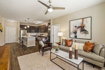 Baton Rouge apartment for rent - A living room with a grey couch and a painting on the wall.