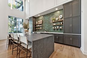Collierville apartment for rent - a kitchen with black cabinets and a marble counter top