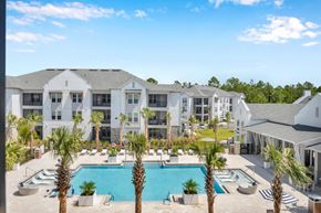 St. Augustine apartment for rent - A large white building with a pool in front.