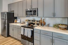 Erlanger apartment for rent - A kitchen with a stainless steel refrigerator and a microwave above the stove.