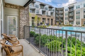 Erlanger apartment for rent - A balcony with chairs and a pool in the background.
