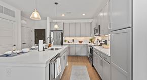 Erlanger apartment for rent - A modern kitchen with white cabinets and a central island.