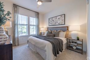 Erlanger apartment for rent - A bedroom with a large bed and a ceiling fan.