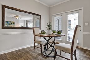 Birmingham apartment for rent - Dining room with plank flooring and fireplace at Village at Caldwell Mill in Birmingham, AL
