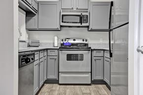 Birmingham apartment for rent - A remodeled kitchen with stainless steel appliances at Village at Caldwell Apartments in Birmingham, AL