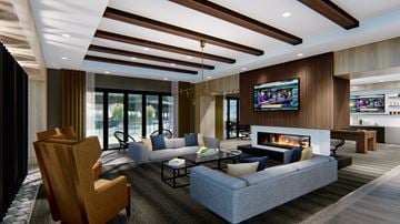 Troy apartment for rent - A modern living room with a fireplace and a television.