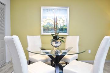 Lexington apartment for rent - a dining room with a glass table and white chairs