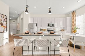 Indian Land apartment for rent - an open kitchen and dining room with white cabinets and a marble counter top
