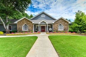 Alpharetta apartment for rent - the front of a house with a yard and a walkway