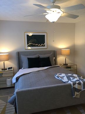 Alpharetta apartment for rent - a bedroom with a bed and a ceiling fan