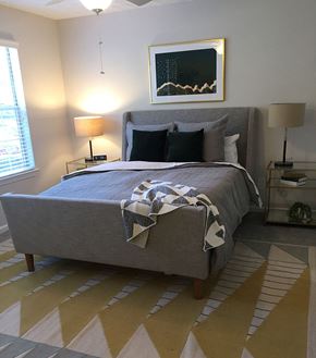 Alpharetta apartment for rent - a bedroom with a bed with a blanket and pillows on it