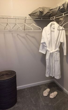 Alpharetta apartment for rent - a white robe and white shoes in a closet