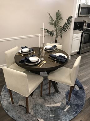 Alpharetta apartment for rent - a dining room with a round table and white chairs