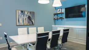 Fairhope apartment for rent - The Flats at East Bay Apartments – conference room with seating for eight and a large tv display