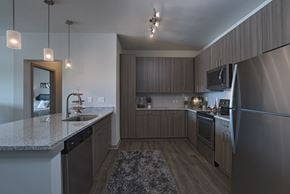 Jackson apartment for rent - A modern kitchen with a granite countertop and stainless steel appliances.