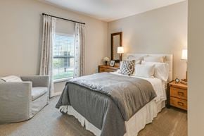 Columbus apartment for rent - a bedroom with a bed and a chair and a window