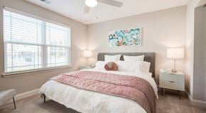Concord apartment for rent - a bedroom with a bed and two windows