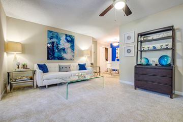 Savannah apartment for rent - A living room with a white couch and a blue painting on the wall.