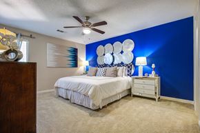 Savannah apartment for rent - A bedroom with a white bed and a blue wall.