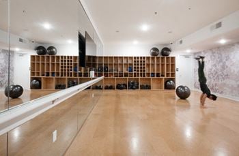 A bowling alley in a gym with a person doing a trick on a bowling ball