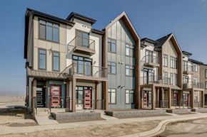 Calgary townhouse for rent - A row of modern townhouses with balconies and garages.