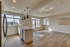 Calgary townhouse for rent - A modern kitchen with wooden floors and a large island.
