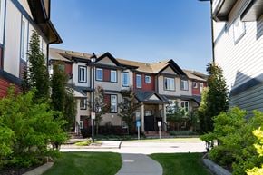 Edmonton townhouse for rent - A row of houses with a clear blue sky above them.