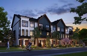 Calgary townhouse for rent - A modern house with a person riding a bicycle in front.