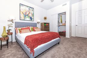 Mesa apartment for rent - Queen sized Platform bed decorated with bright trendy throw pillows in large bedroom in 1x1 model apartment at Ascend at Red Mountain, Arizona
