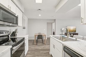 Phoenix apartment for rent - A modern kitchen with a dining table and chairs.