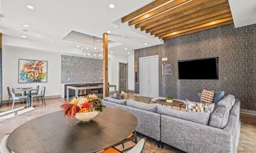 Dallas apartment for rent - A living room with a grey couch, a coffee table, and a painting on the wall.