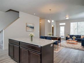 North Salt Lake City townhouse for rent - A modern kitchen with a large island and a painting on the wall.
