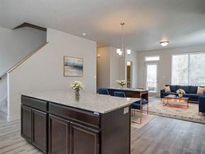 North Salt Lake townhouse for rent - A modern kitchen with a large island and a painting on the wall.