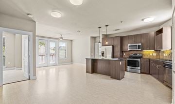Dallas apartment for rent - A spacious kitchen with wooden cabinets and stainless steel appliances.