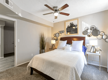 Cozy bedroom with overhead ceiling fan 