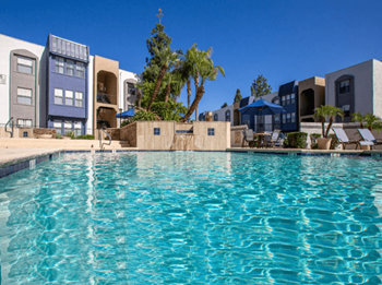 Sparkling resort-style swimming pool with waterfall 