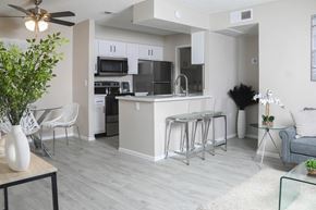 Mesa apartment for rent - an open kitchen and living room with a bar and stools
