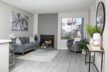 Mesa apartment for rent - a living room with grey couches and a fireplace